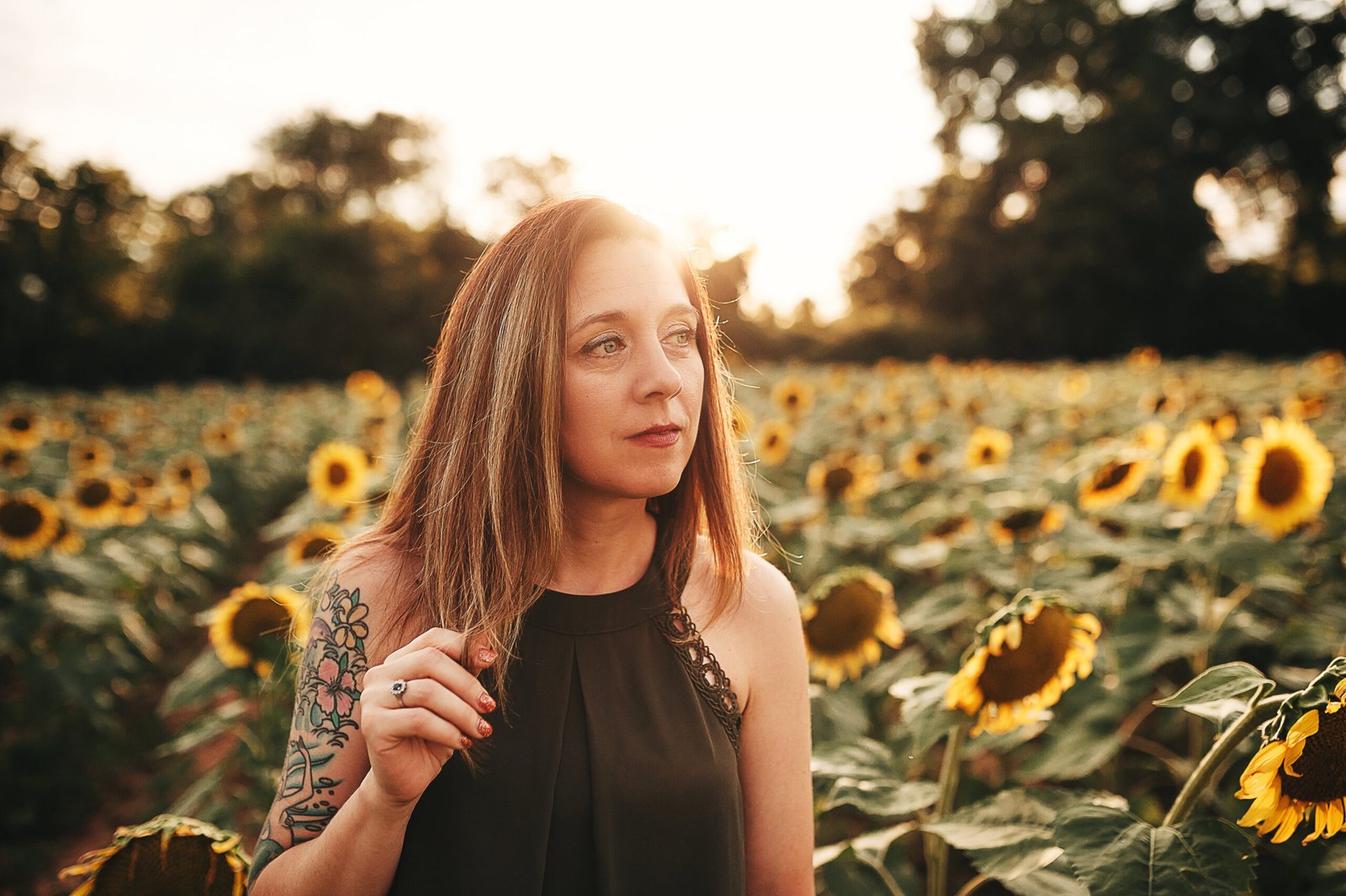 girl-standing-near-sunflowers